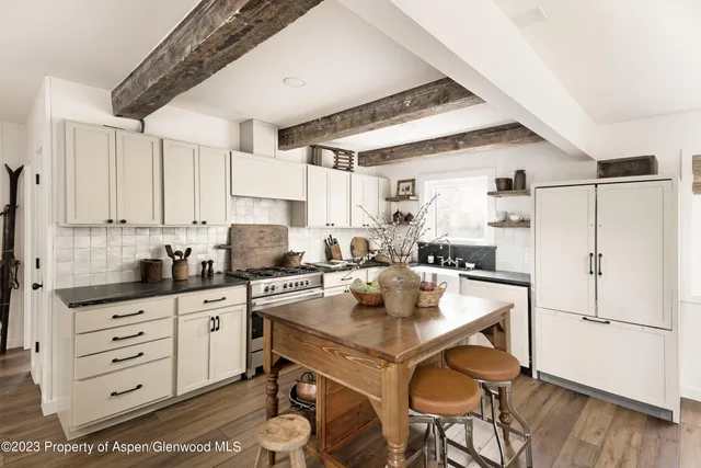 a view of a kitchen with furniture and wooden floor