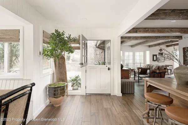 a workspace with wooden floor and furniture