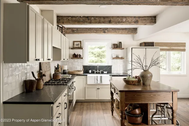 a kitchen with stainless steel appliances kitchen island granite countertop a sink and cabinets