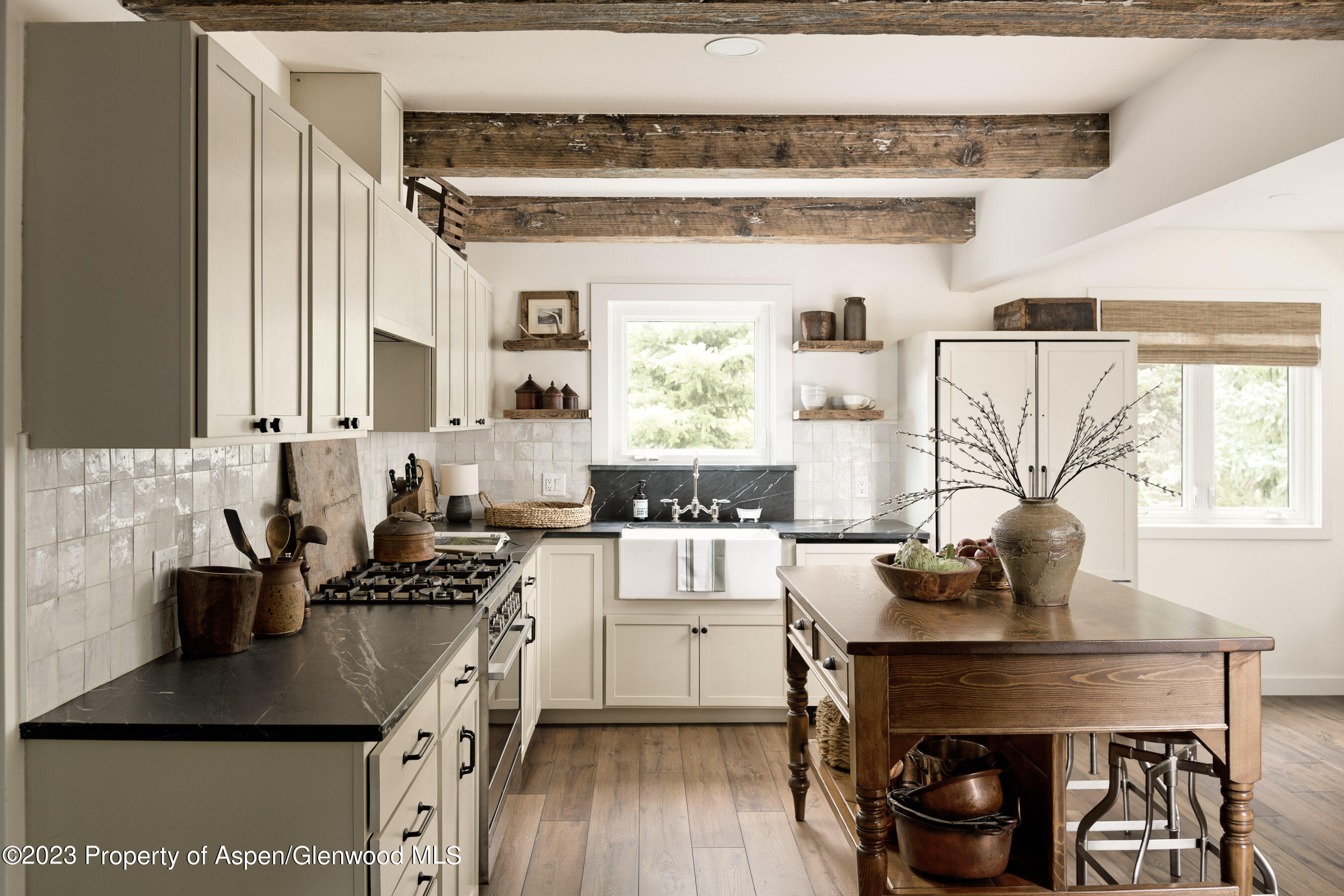 1470 Snowmass Creek Road Snowmass, CO 81654 - Photo 23 of 63 a kitchen with a table chairs a stove and a window