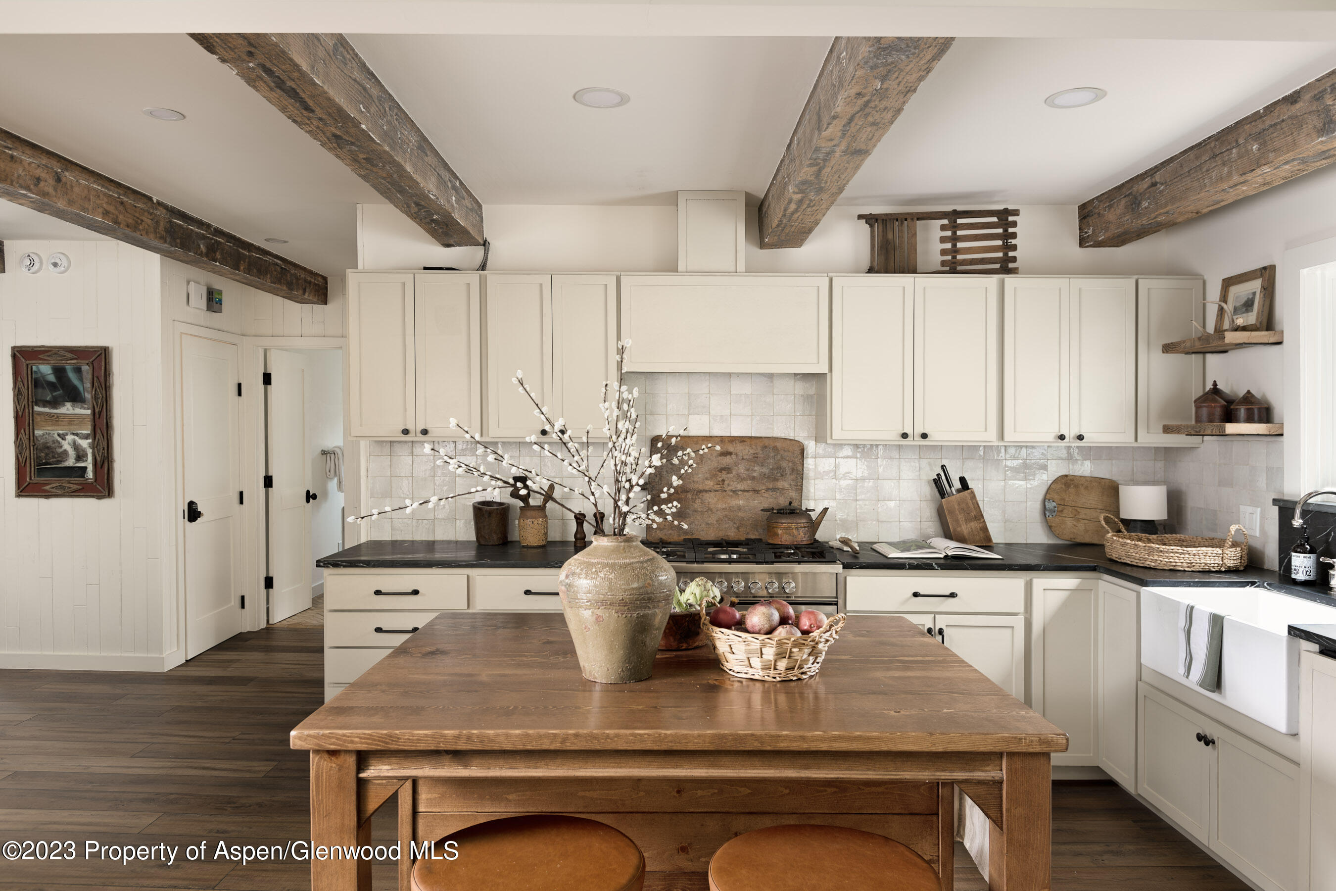1470 Snowmass Creek Road Snowmass, CO 81654 - Photo 28 of 63 a kitchen with stainless steel appliances kitchen island granite countertop a sink and cabinets