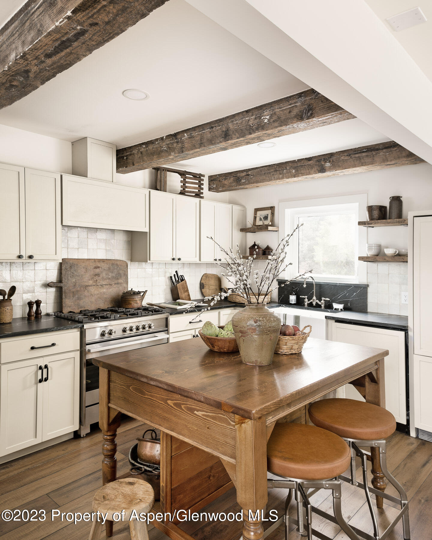 1470 Snowmass Creek Road Snowmass, CO 81654 - Photo 29 of 63 a kitchen with a stove a table and chairs in it
