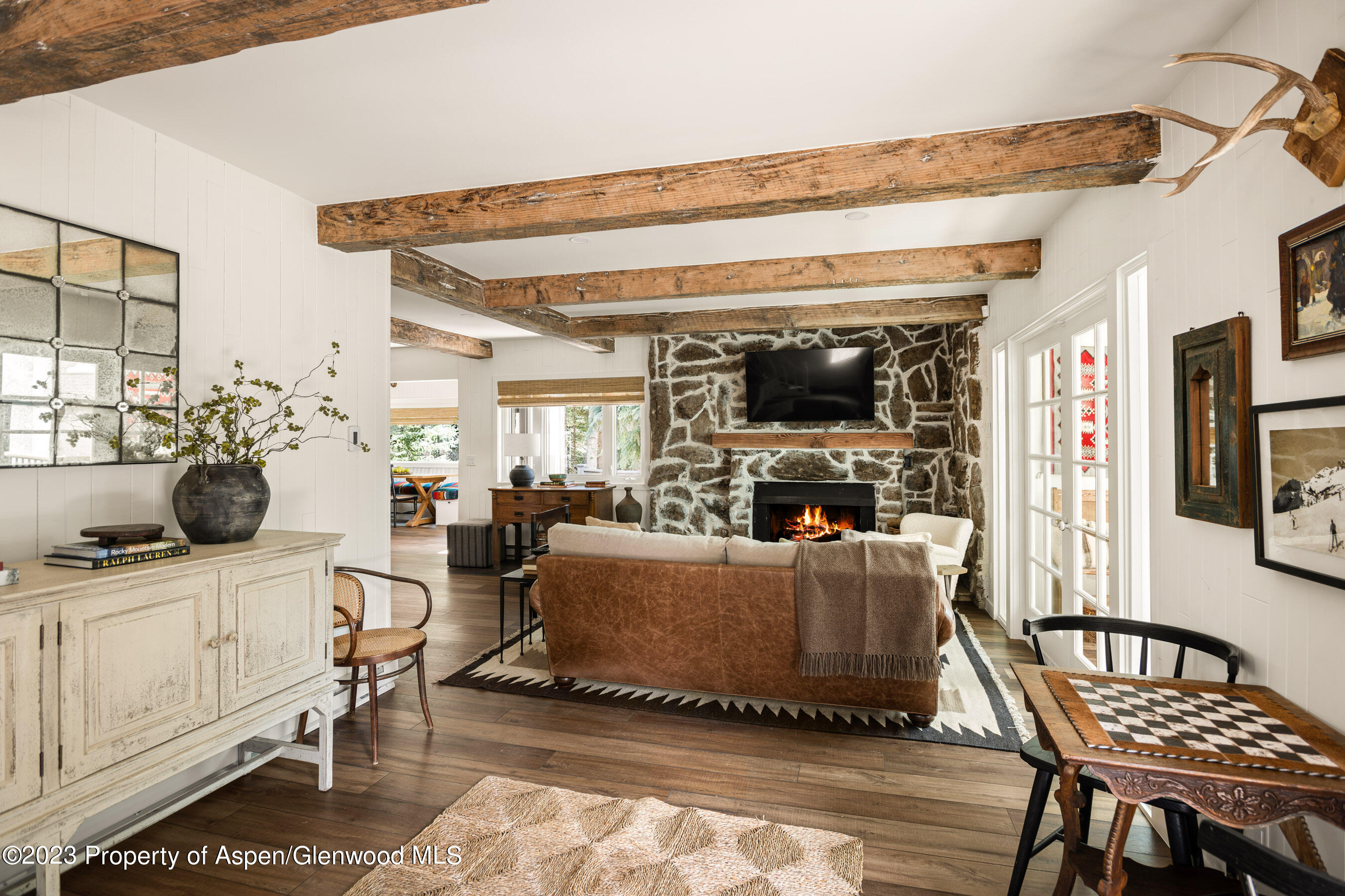 1470 Snowmass Creek Road Snowmass, CO 81654 - Photo 31 of 63 a living room with furniture and a flat screen tv