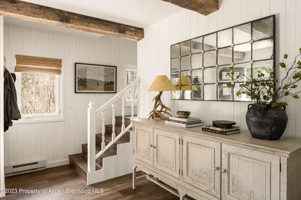 a view of a chairs and bench in a room