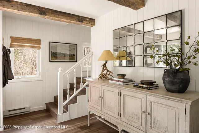 a view of a chairs and bench in a room