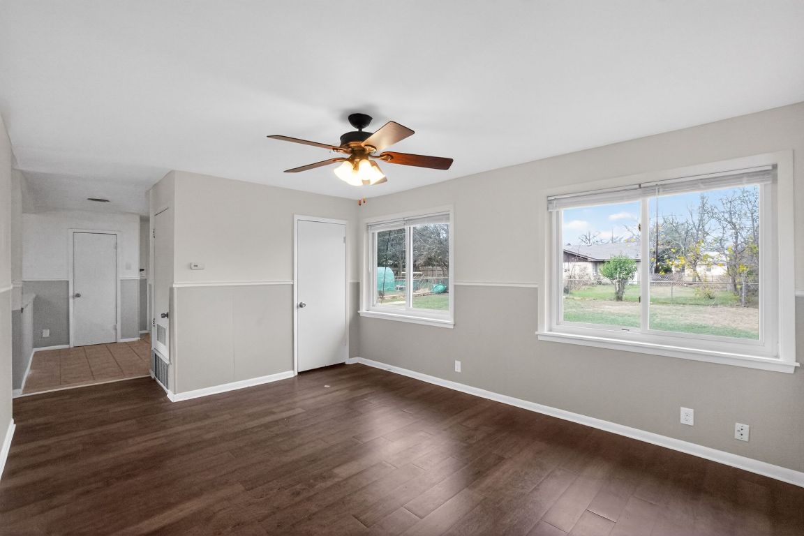 105 Shannon Lane Georgetown, TX 78628 - Photo 11 of 15 a view of an empty room with wooden floor and a window