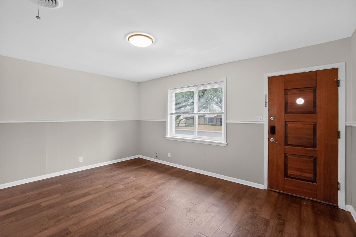 105 Shannon Lane Georgetown, TX 78628 - Photo 2 of 15 an empty room with wooden floor and windows