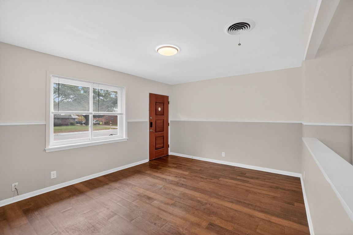 105 Shannon Lane Georgetown, TX 78628 - Photo 6 of 15 an empty room with wooden floor and windows