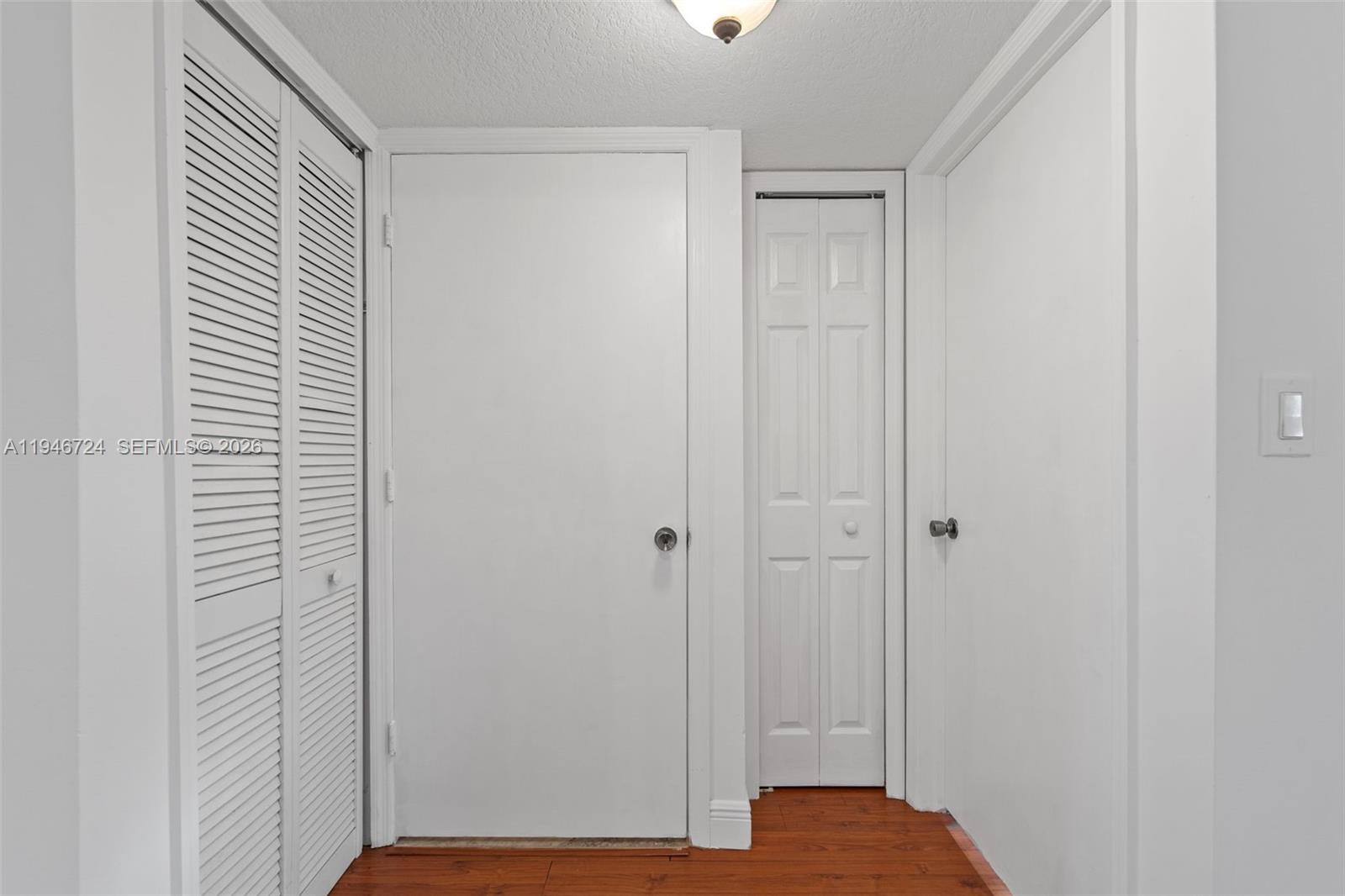 945 Northeast 34th Avenue, Unit 103 Homestead, FL 33033 - Photo 11 of 40 Right door is guest bedroom entrance. Moving left is a storage closet. The door to the left of that is the bathroom door.