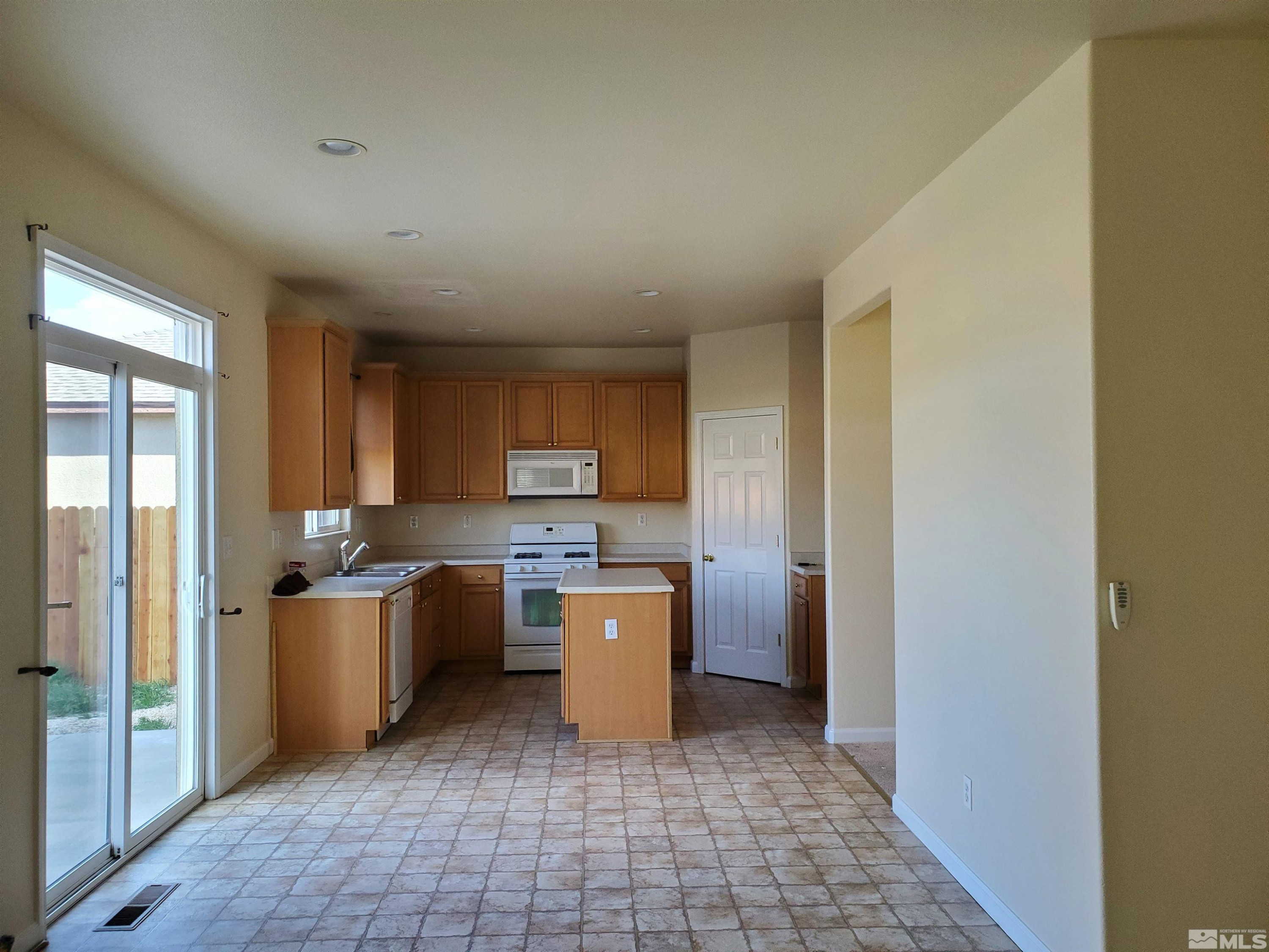 2306 Clementine Lane Reno, NV 89521 - Photo 13 of 16 a kitchen with a sink a stove and refrigerator