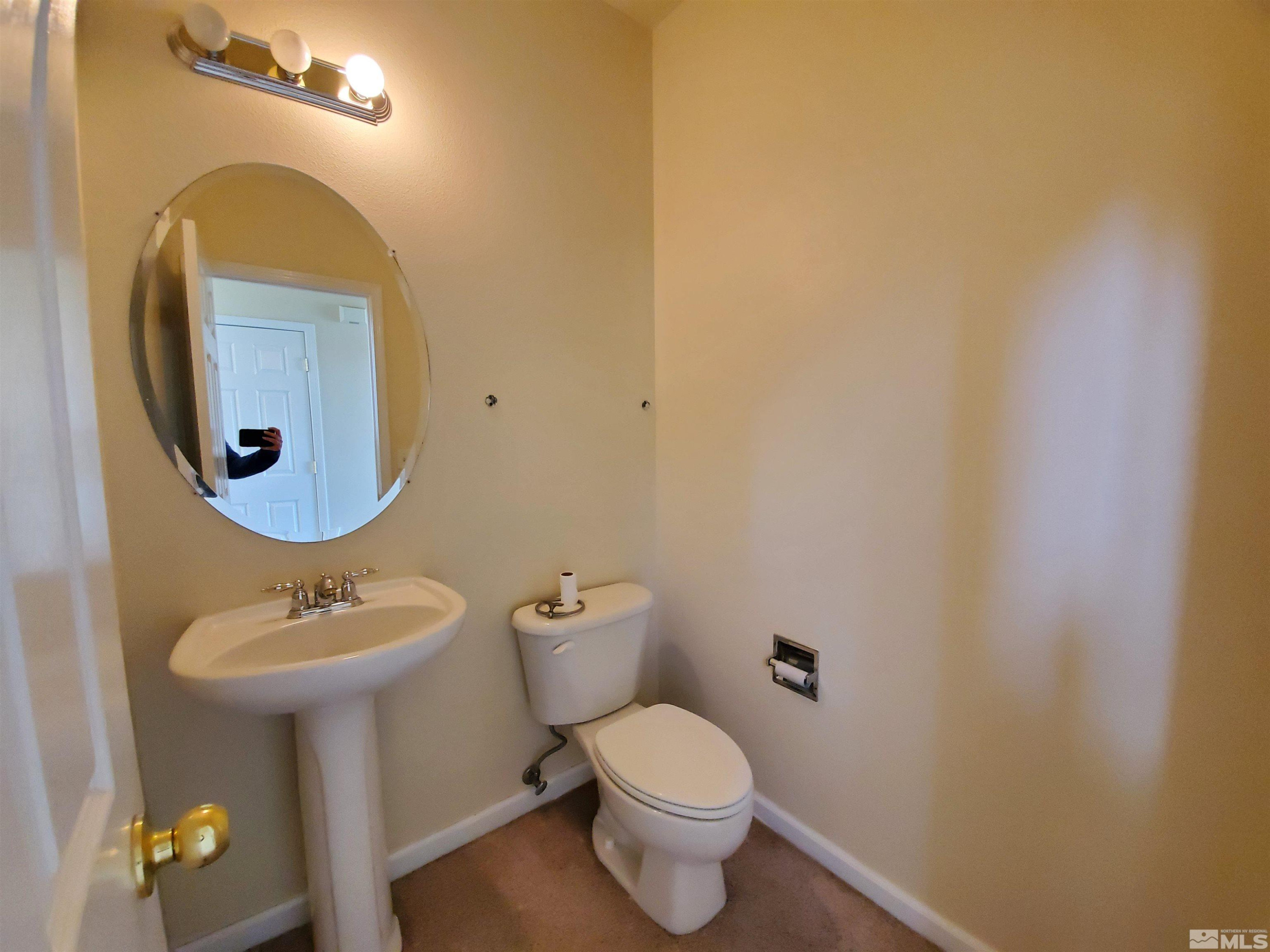 2306 Clementine Lane Reno, NV 89521 - Photo 16 of 16 a bathroom with a toilet sink and mirror