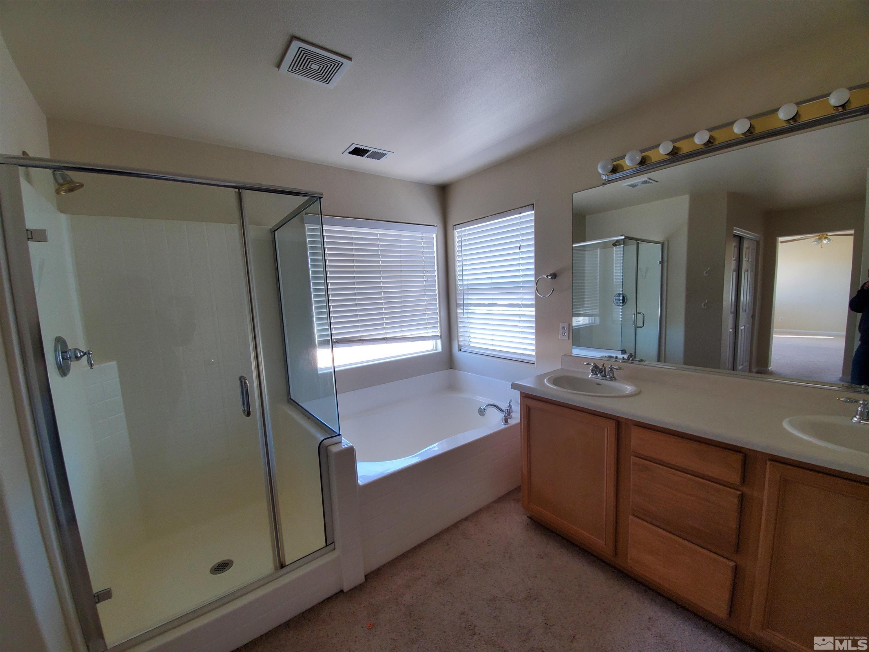 2306 Clementine Lane Reno, NV 89521 - Photo 2 of 16 a bathroom with a double vanity sink mirror and shower