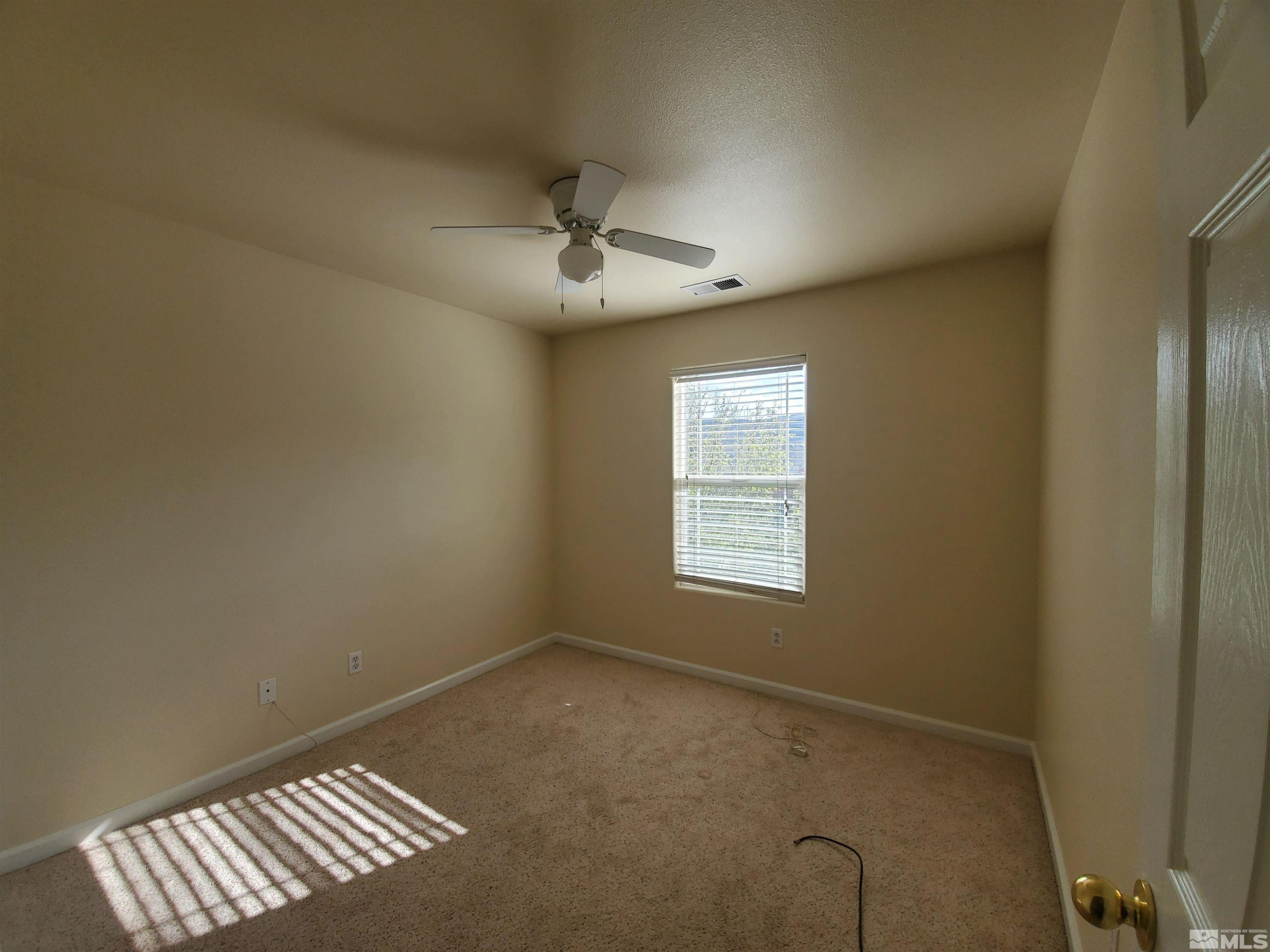 2306 Clementine Lane Reno, NV 89521 - Photo 6 of 16 a view of an empty room with a window