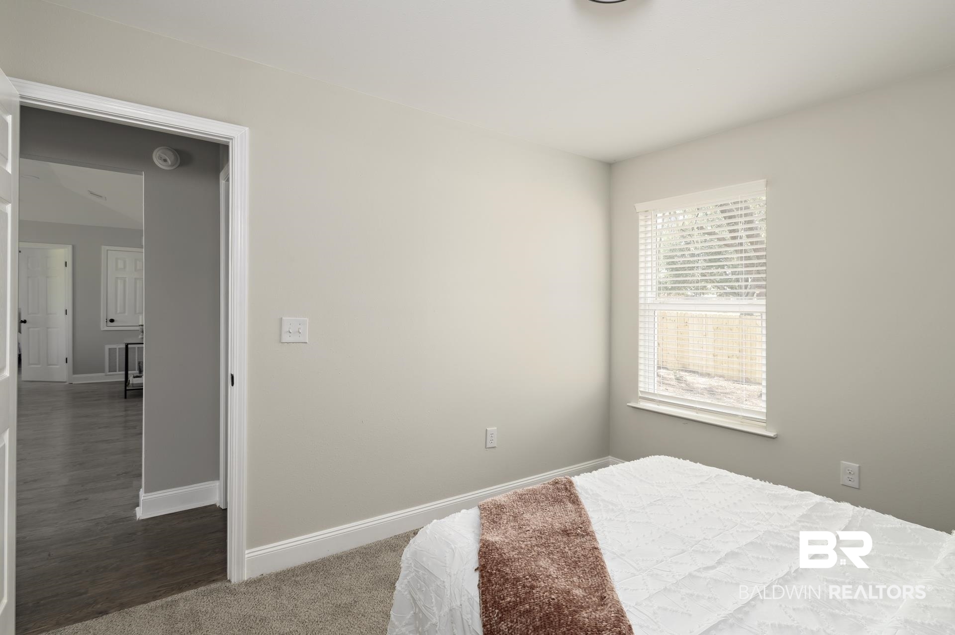 21717 Shadowbrook Street Robertsdale, AL 36567 - Photo 13 of 32 Bedroom with dark colored carpet and baseboards