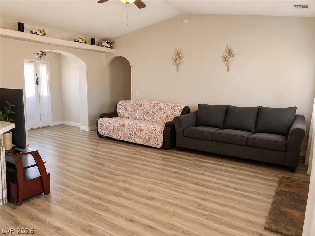 200 East Gamebird Road Pahrump, NV 89048 - Photo 5 of 23 Arched doorways and light wood flooring define this open-concept living space.