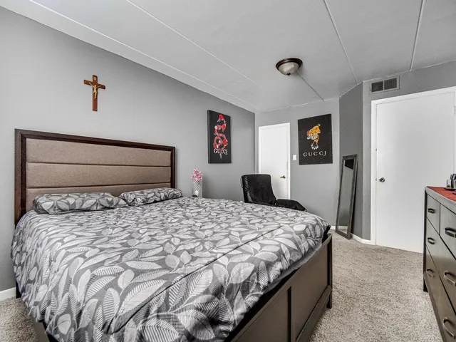 a bedroom with a large bed and a window