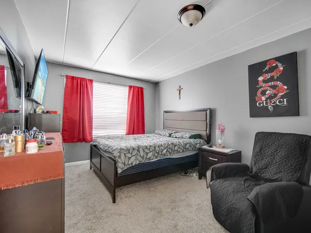 a bedroom with furniture and a window