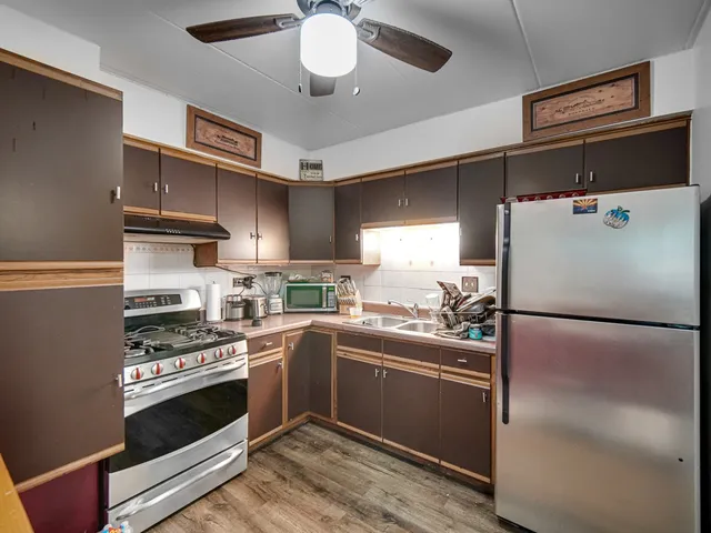 a kitchen with a appliances and a refrigerator