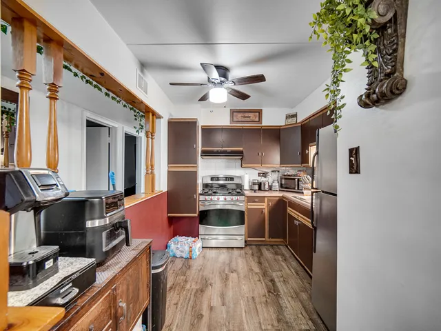 a kitchen with stainless steel appliances granite countertop a stove and a refrigerator