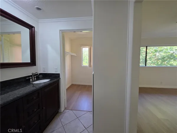 a bathroom with a granite countertop sink a mirror and a vanity