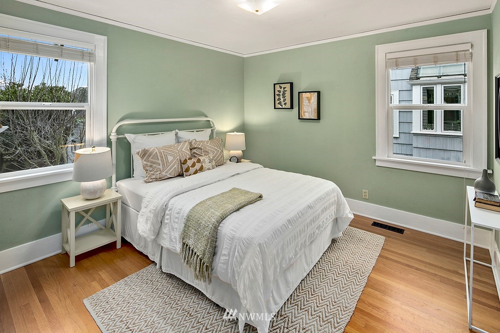 537 Northeast 82nd Street Seattle, WA 98115 - Photo 20 of 28 a bedroom with a bed wooden floor and window