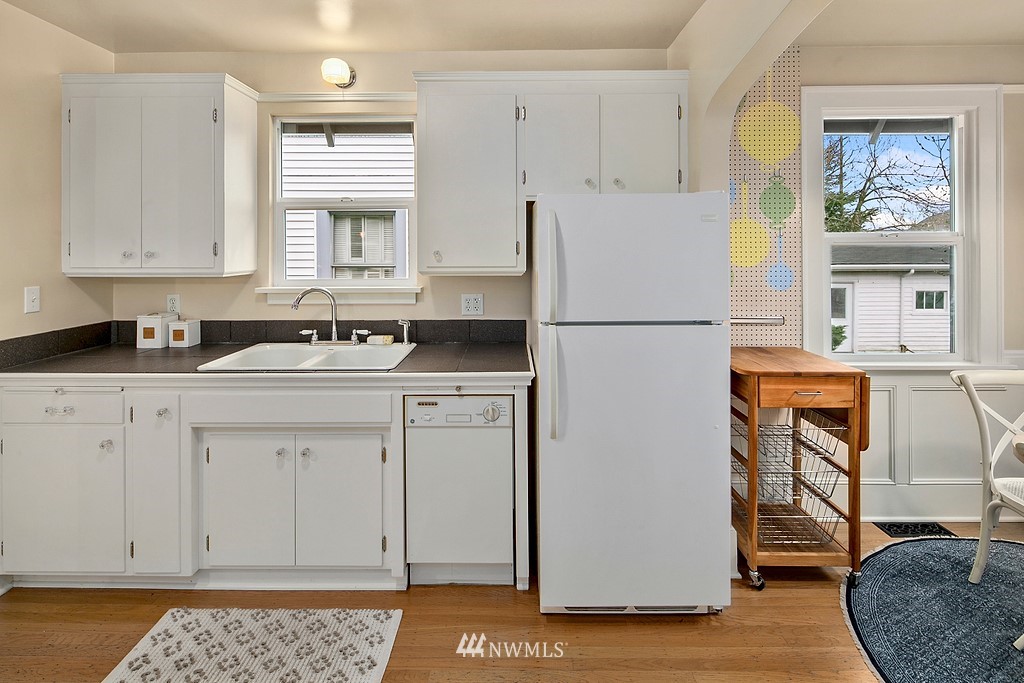 537 Northeast 82nd Street Seattle, WA 98115 - Photo 8 of 28 a white refrigerator freezer sitting inside of a kitchen