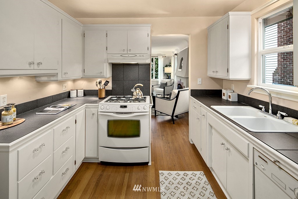 537 Northeast 82nd Street Seattle, WA 98115 - Photo 10 of 28 a kitchen with a sink stove and cabinets