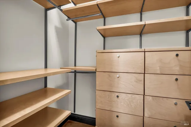 a view of a hallway with wooden floor and dining room