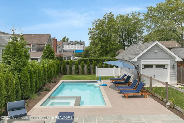 a view of a patio with couches table and chairs and potted plants