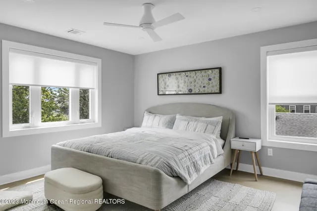 a bedroom with a bed and a window with chair