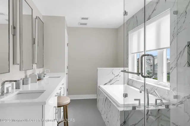 a bathroom with a tub sink and mirror