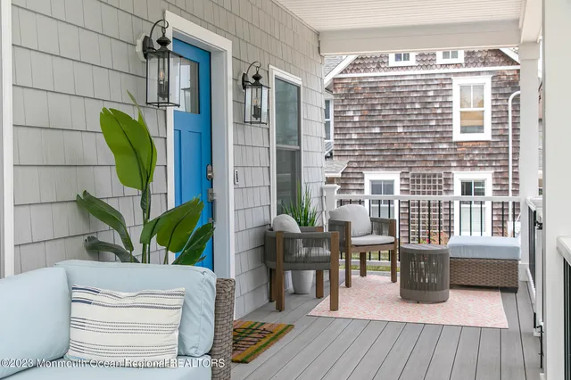 a living room with furniture a wooden floor and a potted plant