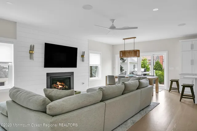 a living room with furniture flat screen tv and a fireplace