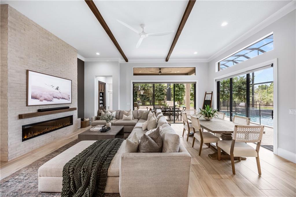 a living room with furniture and large windows