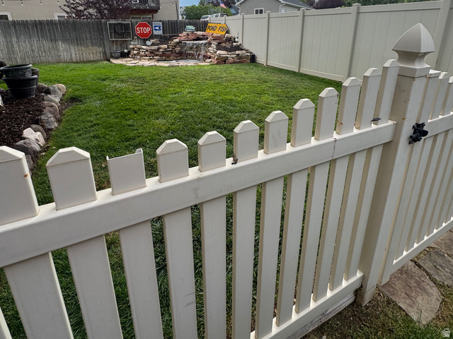 1237 South 260 West Payson, UT 84651 - Photo 11 of 81 Expansive backyard featuring a manicured lawn, a decorative rock formation, and a white picket fence