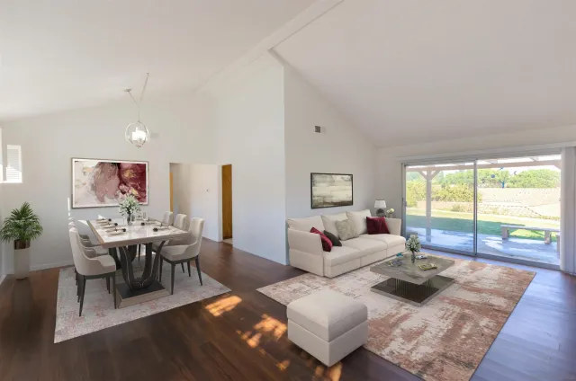 a living room with lots of furniture and a large window