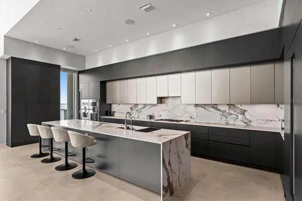 a kitchen with a sink a stove a refrigerator and cabinets