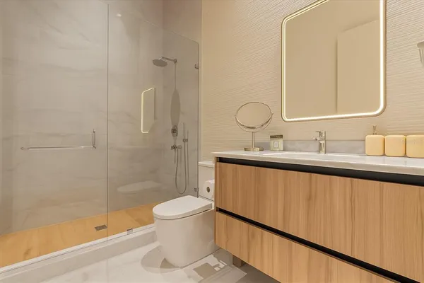 a bathroom with a sink a toilet and shower