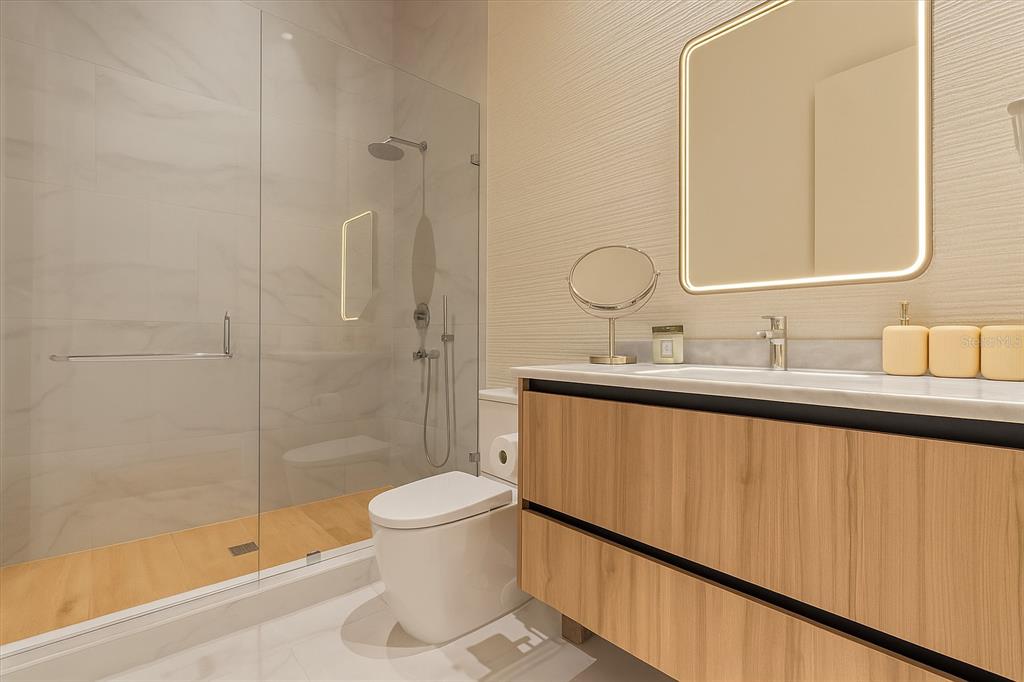 1020 Sunset Point Road, Unit 703 Clearwater, FL 33755 - Photo 14 of 50 a bathroom with a sink a toilet and shower