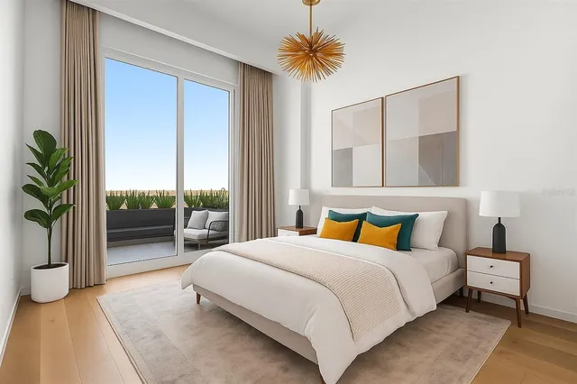 a bedroom with a bed and a potted plant