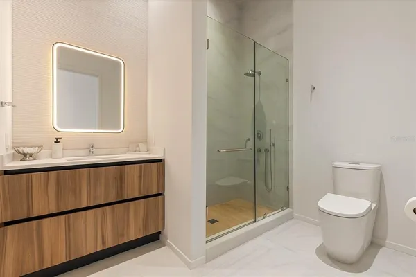 a bathroom with a toilet a sink and shower