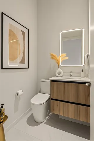 a bathroom with a toilet a sink and mirror