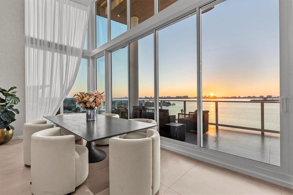 1020 Sunset Point Road, Unit 703 Clearwater, FL 33755 - Photo 2 of 50 a dining room with furniture and large windows