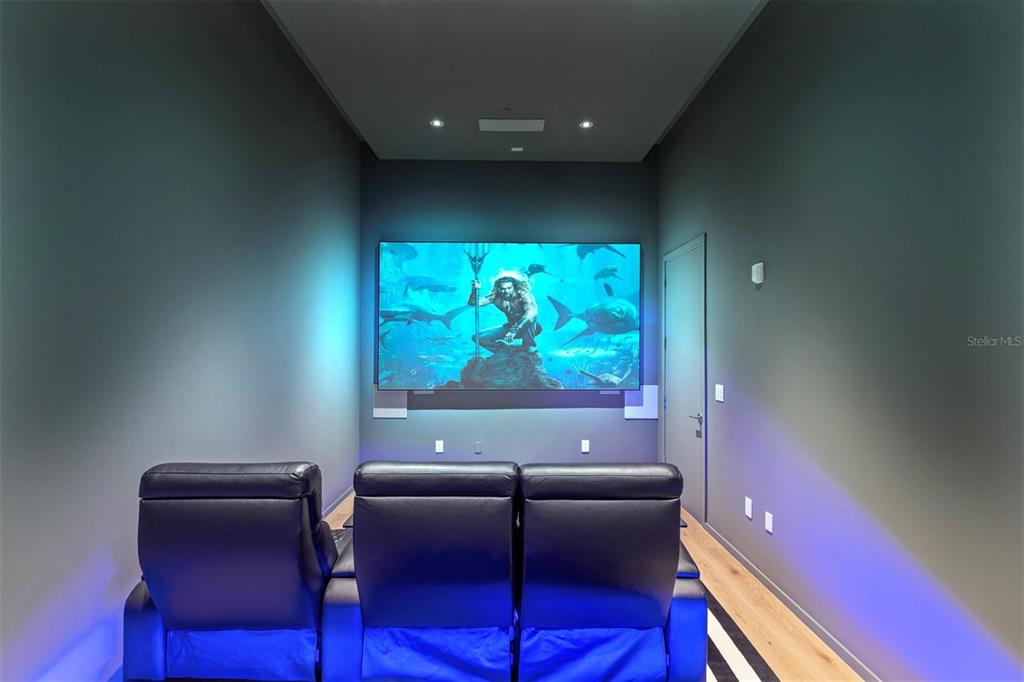 1020 Sunset Point Road, Unit 703 Clearwater, FL 33755 - Photo 23 of 50 a projector room with furniture and screen