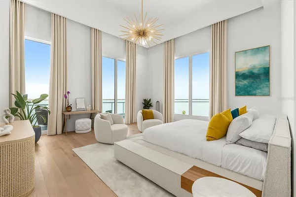 a bedroom with a bed and a large window