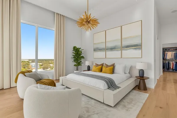 a bedroom with a bed and a large window