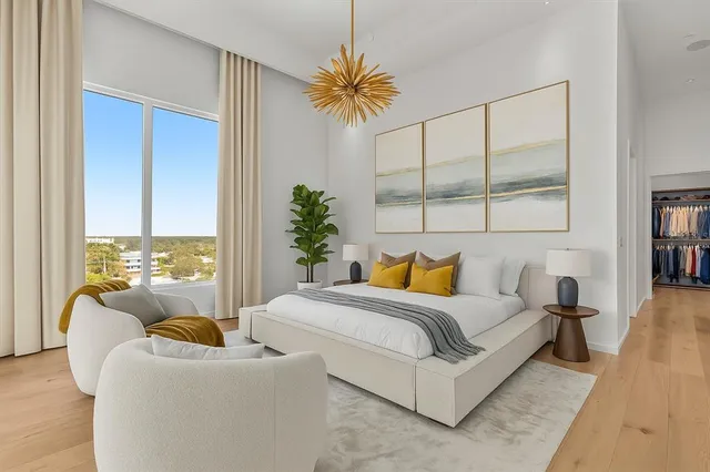 a bedroom with a bed and a large window