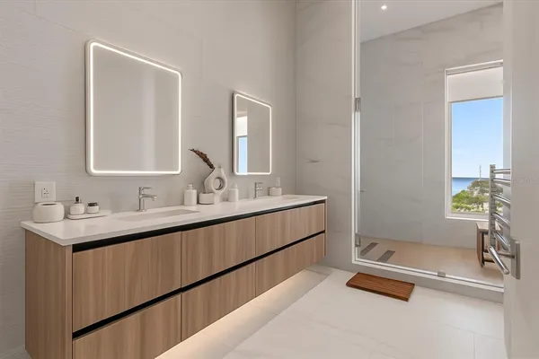 a bathroom with a double vanity sink and a mirror