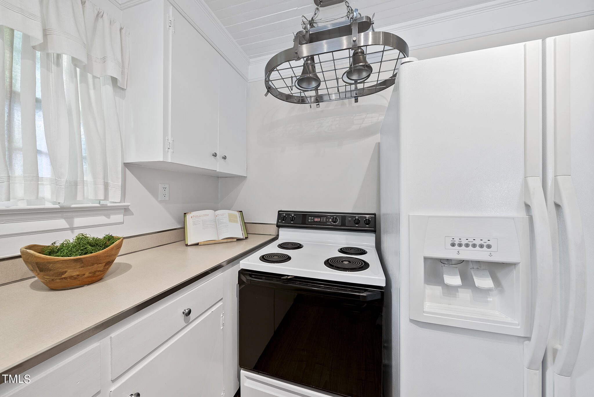 215 Pace Street Raleigh, NC 27604 - Photo 7 of 25 a kitchen with a sink and a stove with white countertops