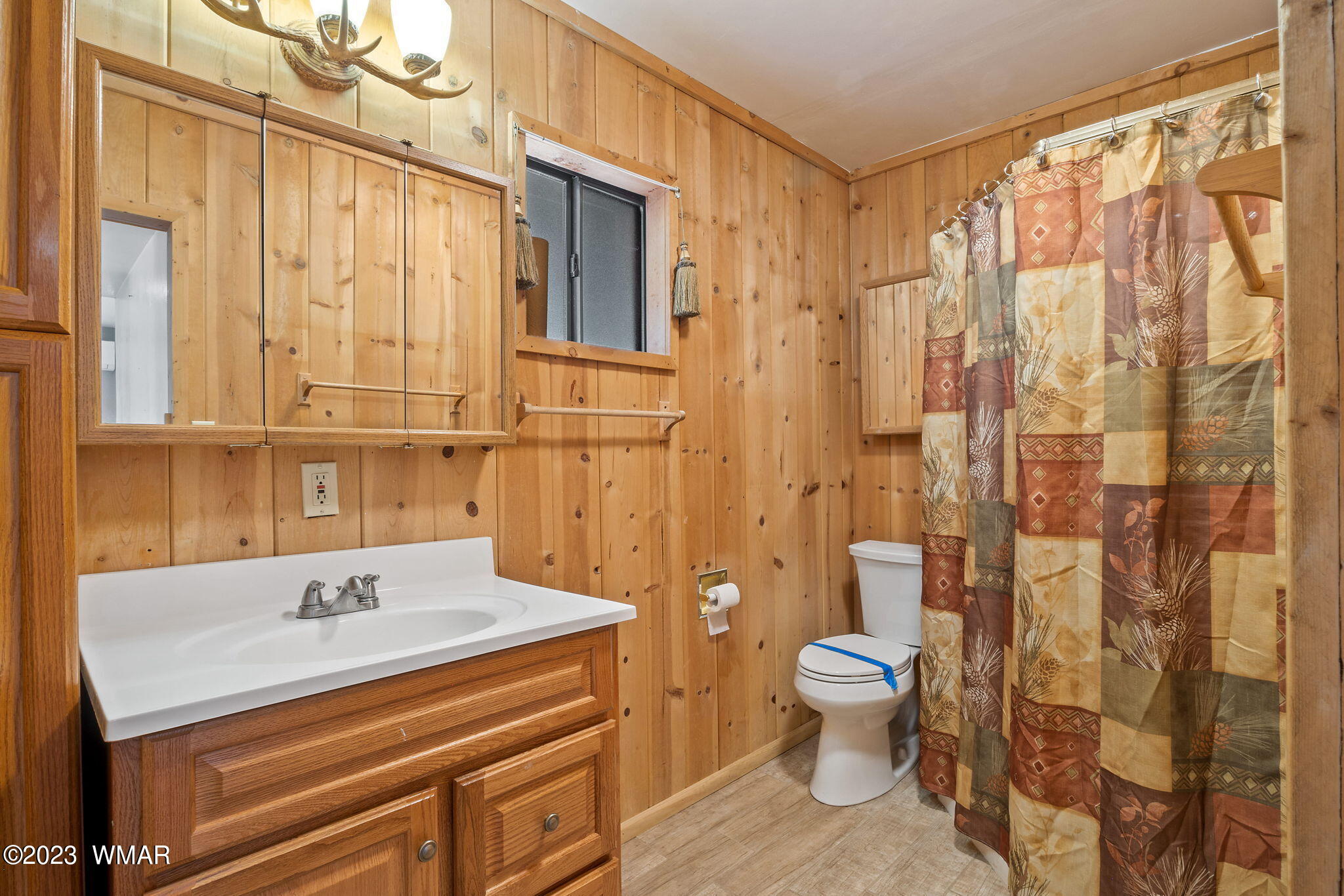 2001 Judy Ranch Road Overgaard, AZ 85933 - Photo 12 of 41 a bathroom with a sink a toilet and shower curtain